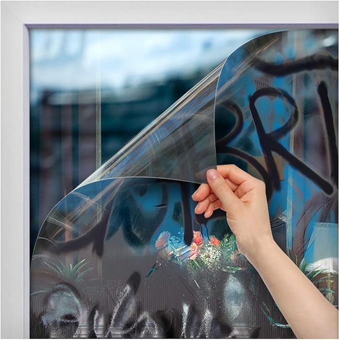 Anti-graffiti window film being applied to protect glass from vandalism